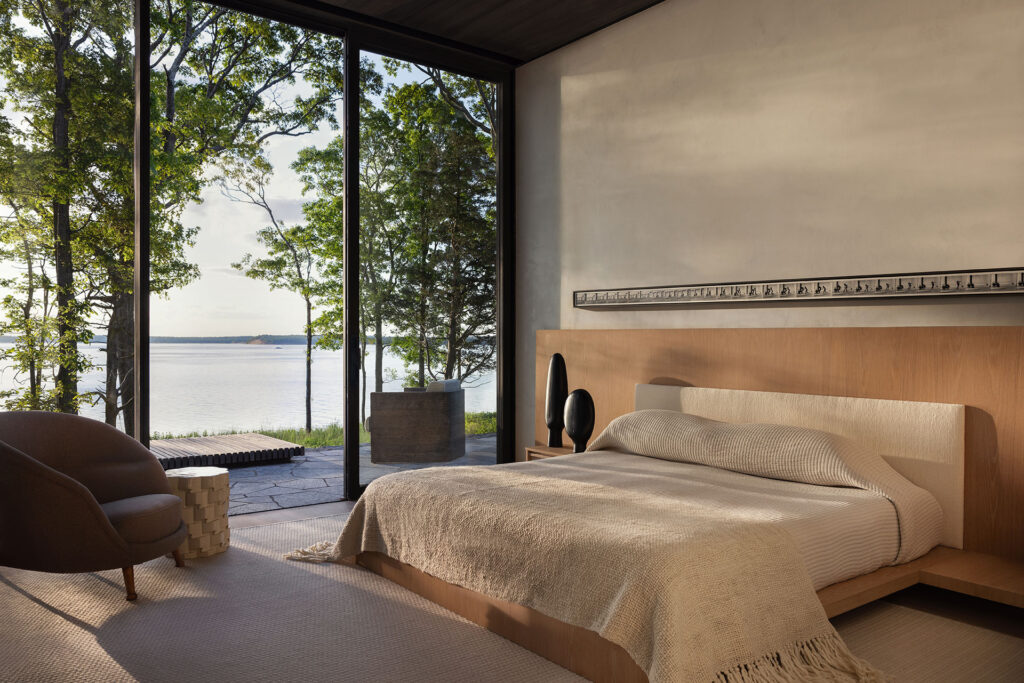 The Bay House — primary bedroom opening to the waterfront