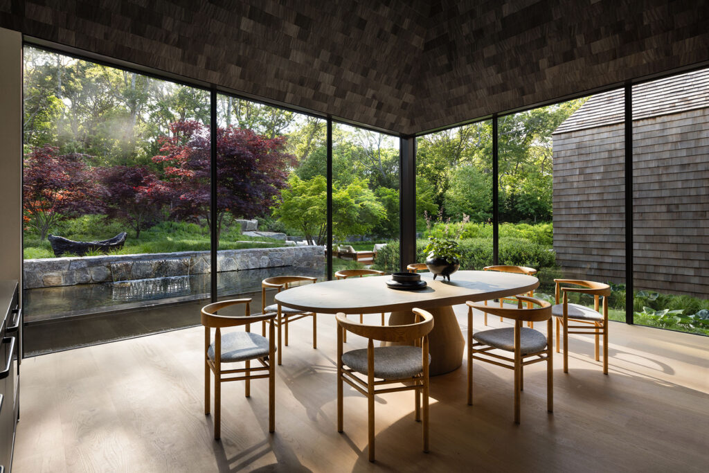 The Bay House — glass dining pavilion overlooking a water garden