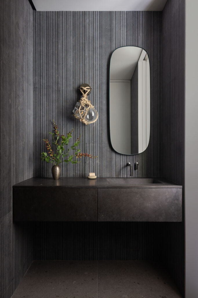 The Bay House — sculpted stone powder room